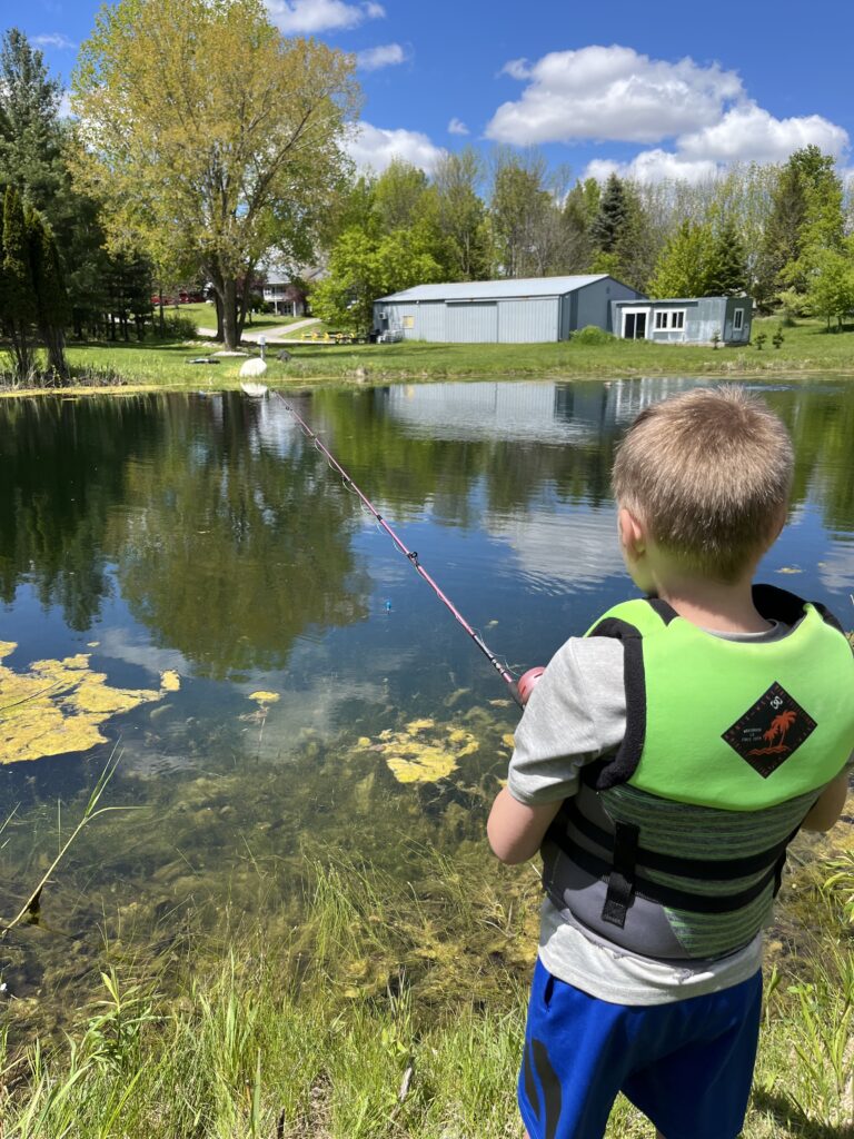 A boy fishing by the pond
